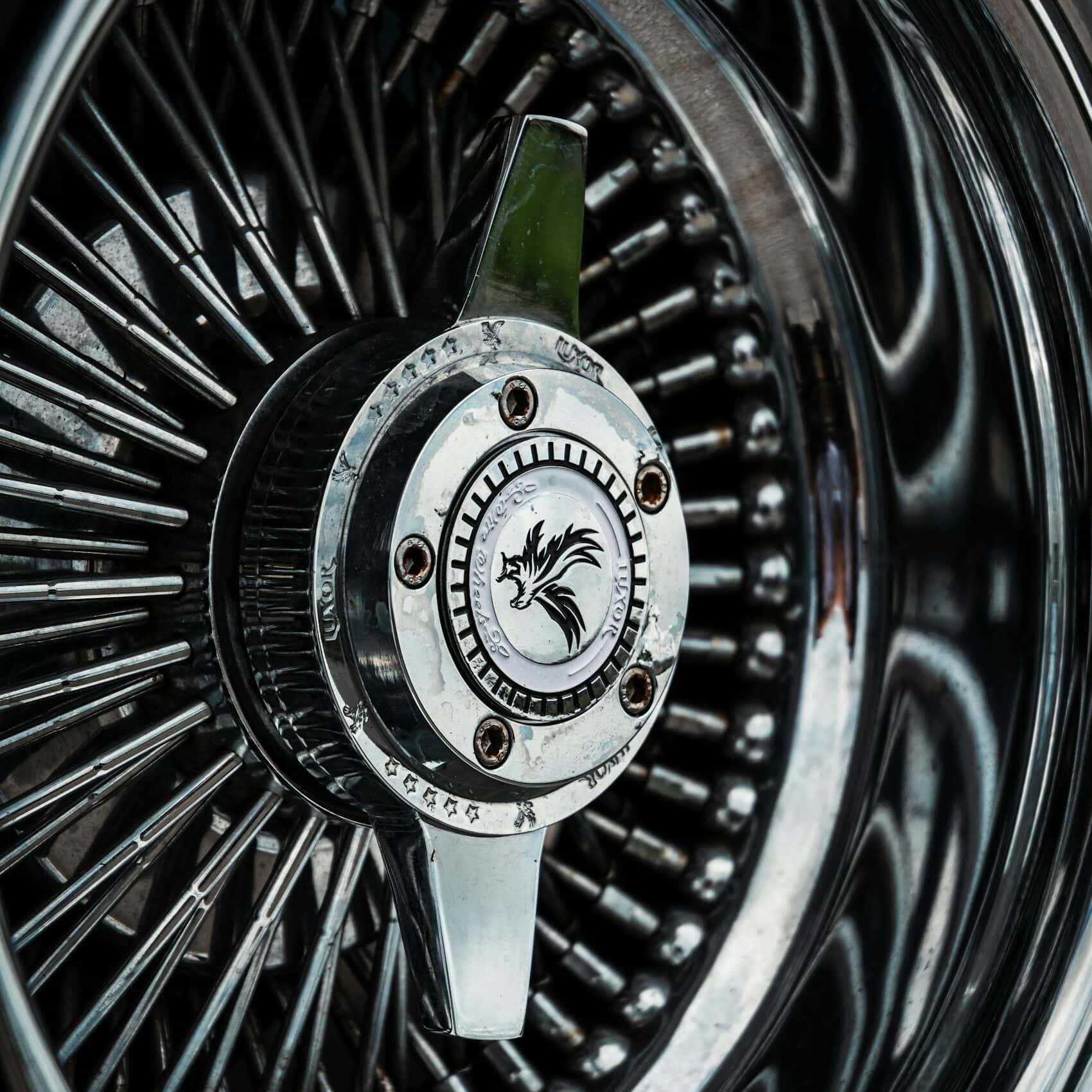Detailed close-up of a shiny chrome vehicle wheel with intricate spokes.